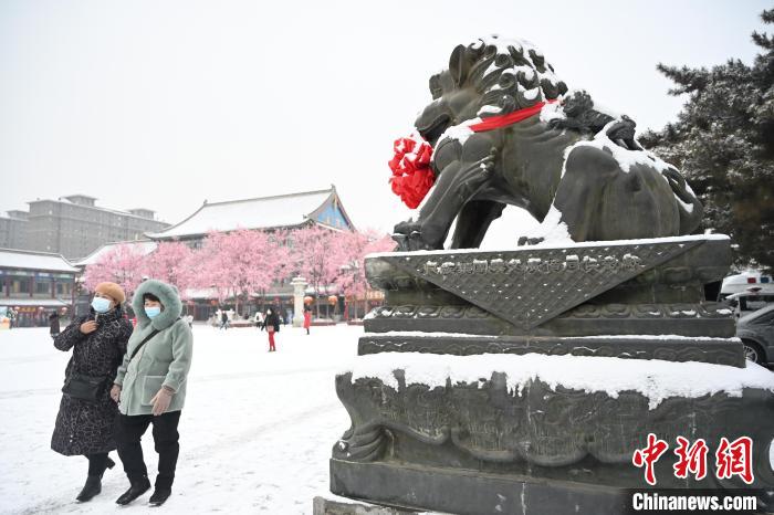 2月13日，民眾在呼和浩特市大召廣場(chǎng)雪中漫步?！⑽娜A 攝