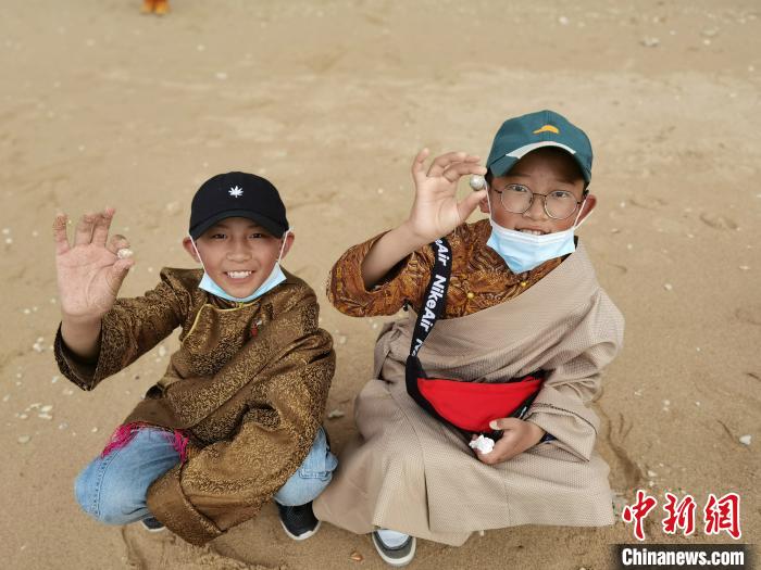 圖為西藏青少年在海邊拾貝殼。西藏航空 供圖