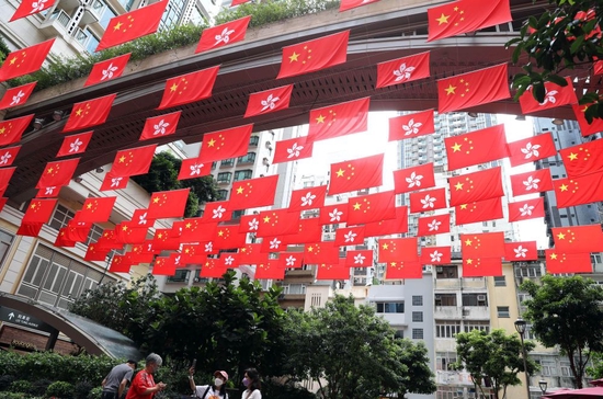  6月16日，在香港利東街，中華人民共和國國旗和香港特別行政區(qū)區(qū)旗迎風飄揚。新華社記者 李鋼 攝